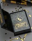Froggy Party product packaging with black and gold colors on a gray background with confetti.