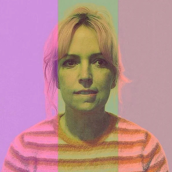 Person with colorful hair and striped sweater on a multicolored background